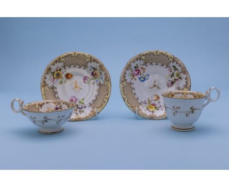 A TEA CUP AND COFFEE CUP WITH SAUCERS
Mid-19th Century
delicately painted with flowers, scrolling gild borders and scale grou