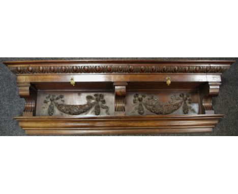 A 19th century oak overmantel shelf profusely carved holding two drawers above carved brackets and carved panels decorated wi