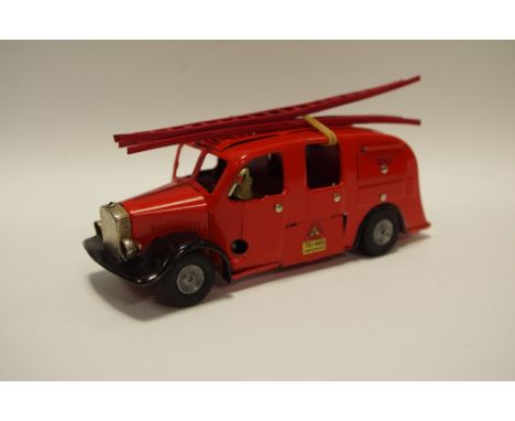 A Tri-ang Minic Fire Engine red body with two red plastic ladders, brass bell, metal hubs, head lamps 