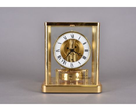 A Jaeger LeCoultre Atmos mantel clock, 19 cm wide x 23 cm high x 15.5 cm deepbrass with light surface scratches, glass genera