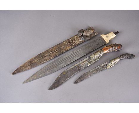 A Middle Eastern knife, having engraved bone handle, with yellow metal decorative mount, the white metal engraved blade with 