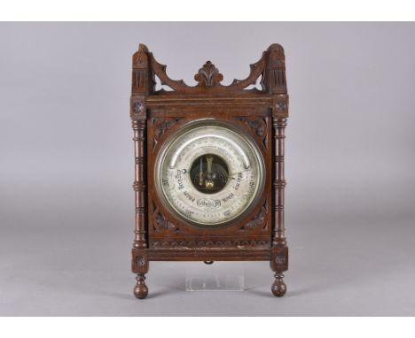 A Victorian walnut carved aneroid barometer, by H Hughes &amp; Sons, 43 cm x 25 cm 