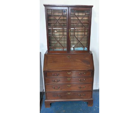 A 19th Century elevated bookcase and associated bureau, astragal glazed doors, adjustable wood and glass shelves, above a Geo