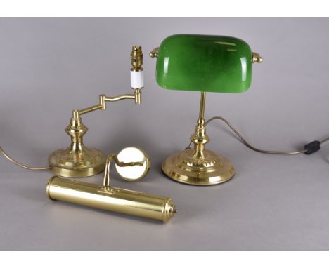 Three 20th Century brass lamps, comprising a bankers lamp with adjustable green glass shade, a desk lamp with adjustable swin