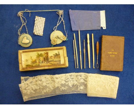A collection of needlework items including 'The Fancy-Work Book Containing Instructions in the Various Kinds of Fancy Needle-