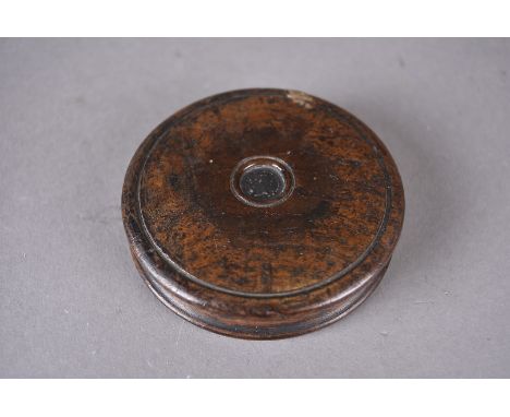 A 19th Century oak circular snuff box, the turned box centred with silver Victorian coin, 8.2 cm diameter 