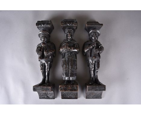 A set of four carved oak corbels, modelled as musicians, all on carved bracket supports, 36 cm, together with a wicker trug, 