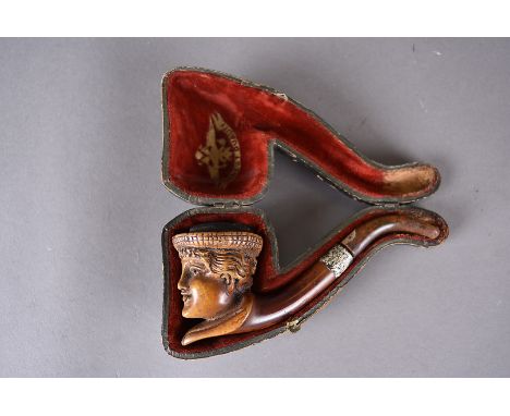 A 19th Century carved meerschaum and amber pipe,  bowl carved with the face of young woman in bonnet, fitted leather case, 15