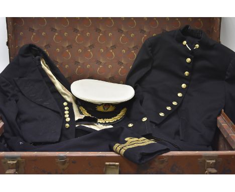 An assortment of Naval Commander's uniforms, including a greatcoat, three jackets and trouser sets, all with WWII ribbons, tw