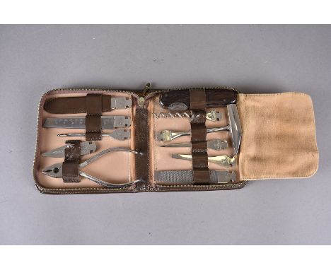 A leather bound pocket tool kit by Dreizack Solingen, in original brown leather fitted case marked VDO, comprising pliers, co