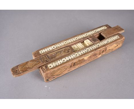 A POW straw work cribbage board and dominos, the wooden container having rural building design to top, with inset bone cribba