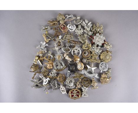 An assortment of British and Overseas cap badges, to include, Norfolk Regt, A.A.C, British American, Army Cyclist Corps, The 