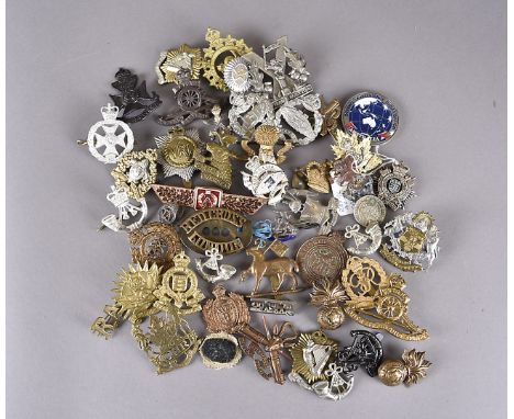A collection of British and Overseas cap badges, to include Tyneside Scottish, Lancers Regt, South African Heavy Artillery, R