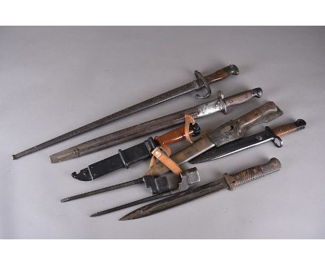 An assortment of bayonets, including a French T-Back, dated 1877, two spike bayonet, a British bayonet, possibly 1907 pattern