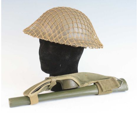 A post WW II Dutch Civil Defence helmet, with scrim net, leather liner and canvas chin strap stamped to the rim VB56 (Verbilf