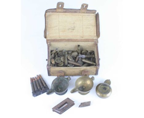 A WW I canvas and brown leather pouch, containing a brass compass case, spent ammunition and shrapnel etc.