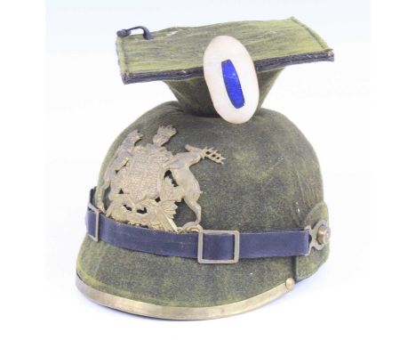A Wurttemberg Uhlan helmet, in green felt, having a mortar board top above a pressed brass plate with singular cockade, leath
