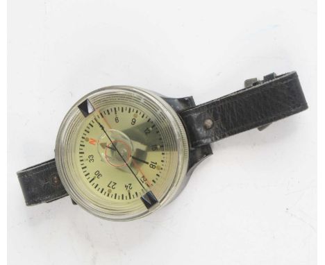 A WW II German Luftwaffe pilot's navigation wrist compass, Kadlec AK39 Fl 23235-1, on a black leather strap, 6cm., together w