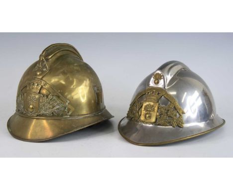 A French brass fire helmet in the Adrian pattern, having a high comb above a brass plate with Sapeurs Pompiers in scroll abov