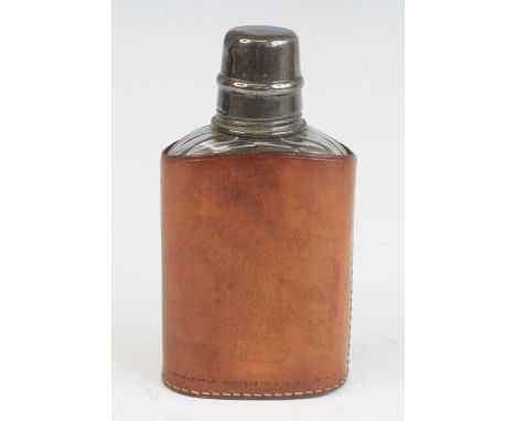 A George V pocket hip flask, having a glass body with removeable silver cap and plated inner screw cap, housed in a leather s