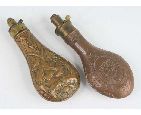 A Victorian copper powder flask, of typical form embossed with a stag and fox head with acorn and leaves, the brass nozzle me