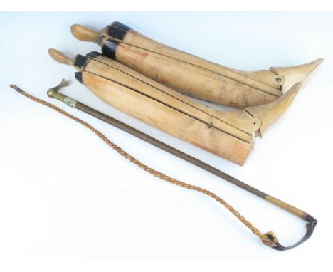 A mid-20th century riding crop, having a plaited leather shaft with brass handle and silver plated collar surrmounted by a ho