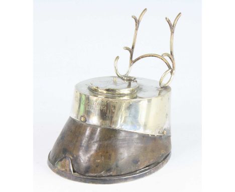 An Edwardian horse hoof inkwell, having a silver plated horse shoe mount and hinged lid with interior glass well, inscribed K