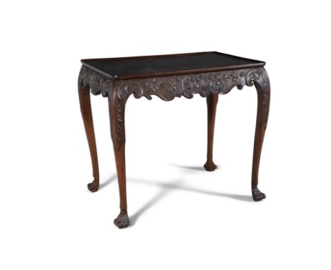 A FINE IRISH GEORGE III MAHOGANY TRAY-TOP CENTRE TABLE,the plain dished top above an undulating mottled apron carved with sca