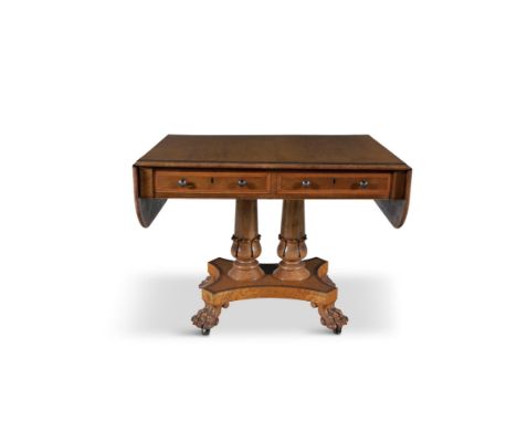 A GEORGE IV SATINWOOD PEDESTAL SOFA TABLE, of shaped rectangular form, the double drop leaf top above twin frieze drawers,&nb