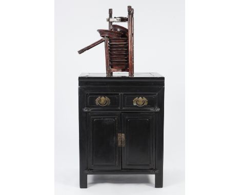 ORIENTAL EBONISED SOFTWOOD SIDE CABINET, the oblong top above a pair of moulded frieze drawers and pair of panelled cupboard 