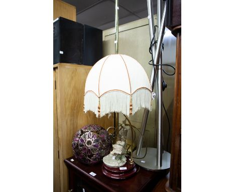 A MODERN TABLE LAMP HAVING FIGURINE FEATURE, WITH TWO CHILDREN BY A TREE AND A MODERN STEEL THREE BRANCH STANDARD LAMP AND AN