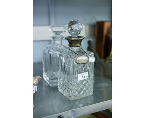 A DECANTER WITH SILVER COLLAR AND SILVER NAME PLATE, ENGRAVED 'PRESENTED TO KEN McEWAN' AND ANOTHER GLASS DECANTER 