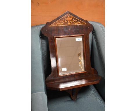 A late 19th or ear;y 20th century hall mirror with inlaid urn decoration and shelf under, width approx. 36cm