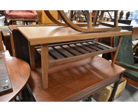A vintage teak or sapele coffee table having slatted undertier, width approx. 112cm