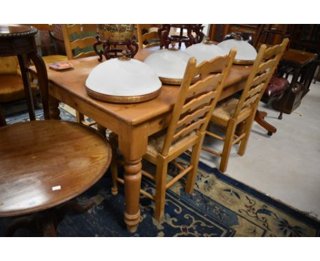 A traditional pine kitchen table, approx 151 x 91cm and a set of four rush seated ladder back chairs