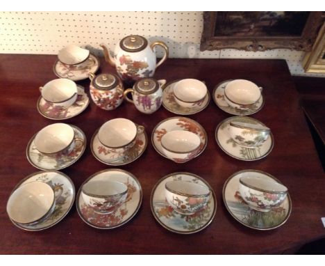 A LATE 19TH CENTURY JAPANESE SATSUMA POTTERY TEA/COFFEE SERVICE  To include a teapot, sugar and cream with lids and twelve cu