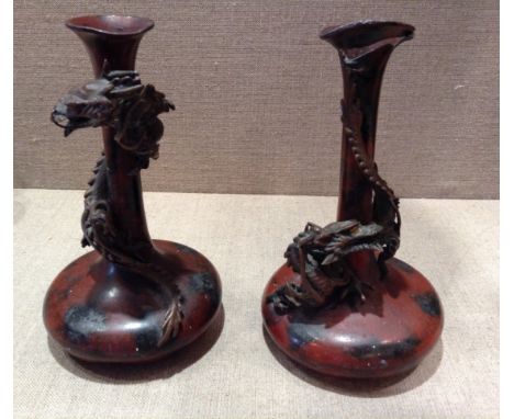 A PAIR OF 19TH CENTURY ORIENTAL BRONZE AND SPELTER VASES The single flower vase, decorated with entwined three claw dragons. 