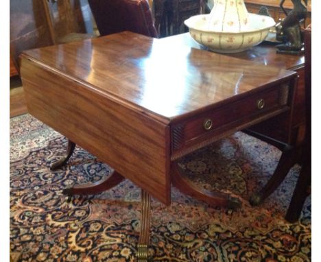 A GEORGE III PERIOD MAHOGANY PEMBROKE TABLE  With real and faux drawers, above a gadrooned border, raised on a single column 