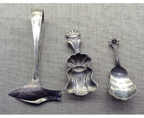 A GEORGIAN SILVER CADDY SPOON With an embossed fluted design, together with a white metal caddy spoon and a pair of hallmarke