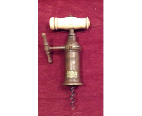 A 19TH CENTURY BRITISH BRONZE AND IVORY CORKSCREW  Having a winding handle, bearing a brass crest of a horse and lion surroun