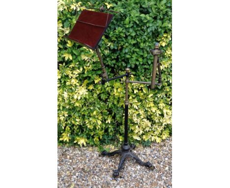 J. CARTER, LONDON, A 19TH CENTURY CAST IRON, MAHOGANY AND BRASS MUSIC STAND AND LAMP Having telescopic pivots, raised on a ca