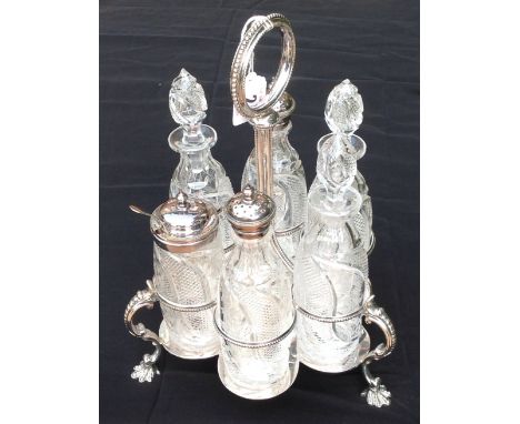 A VICTORIAN SILVER PLATED SIX BOTTLE CRUET STAND With beaded decoration, the cut glass bottles having engraved floral decorat