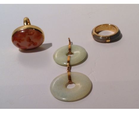 A JADE AND YELLOW METAL BOUND RING Unmarked, along with an 18ct gold and hardstone cabochon ring and a jade double pierced di