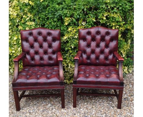 A PAIR OF 20TH CENTURY GAINSBOROUGH DESIGN ARMCHAIRS  In red leather button back upholstery.