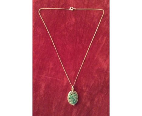 AN OVAL JADE FLOWER DECORATED PIERCED PENDANT Contained in a gold double rope border and suspended from a 14ct gold chain, th