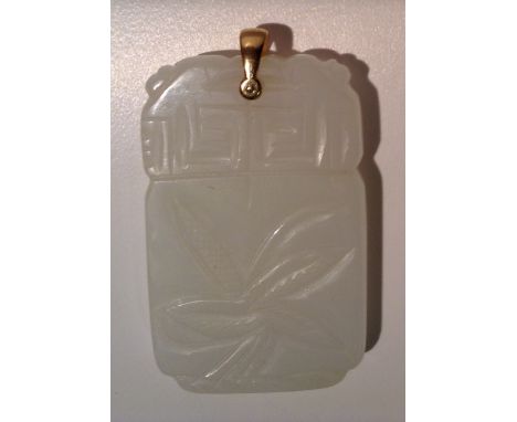 A WHITE JADE TABLET FORM PENDANT Decorated to each side with stylized flora, below a Greek Key band and suspended from a yell