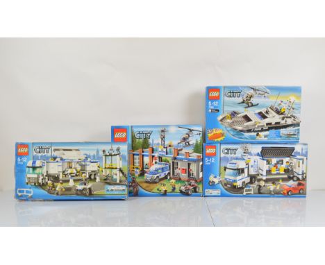 Four boxed Lego City models, including Police Boat 7899 unopened, Forest Police Station 4440 opened with manual and unchecked