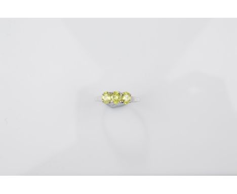 A certificated 9ct gold chrysoberyl three stone dress ring, oval mixed cuts in claw setting in white gold, ring size N, 2g 