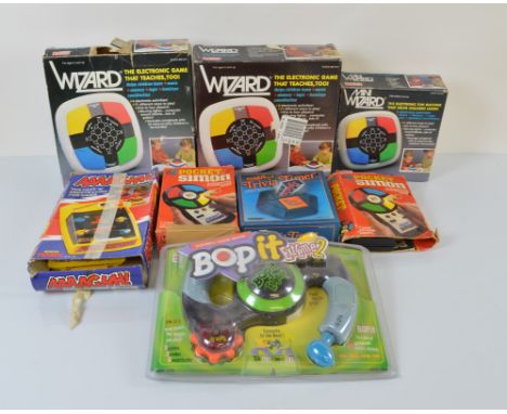 A collection of 1980s and later memory games, including a Bop it, Trivia timer, three Mini Wizard by V Tech, Pocket Simon etc