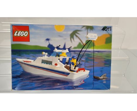 A boxed Lego Cabin Cruiser Set, 4011, opened with manual , unchecked and a box of loose lego 